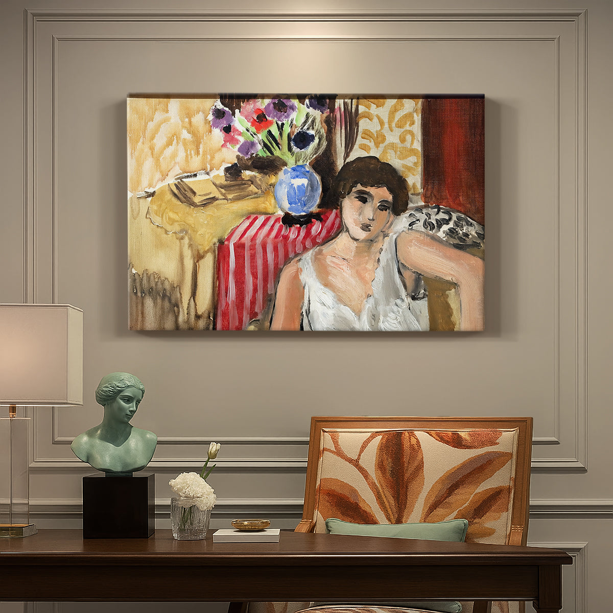 Canvas art print featuring a seated woman in an armchair in a colorful interior, presented within a refined interior setting