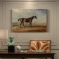 Canvas art print featuring a racehorse standing near coastal landscape with distant water, presented within a refined interior setting