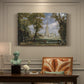 Canvas art print featuring a cathedral rising above landscape with trees, presented within a refined interior setting