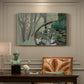 Canvas art print featuring a stream flowing through green landscape, presented within a refined interior setting