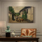Canvas art print featuring figures gathered outside farmhouse greeting one another in village setting, presented within a refined interior setting