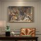 Canvas art print featuring a group of figures gathered indoors sharing food in rustic setting, presented within a refined interior setting