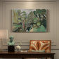 Canvas art print featuring a small figure in a green landscape near trees and buildings, presented within a refined interior setting