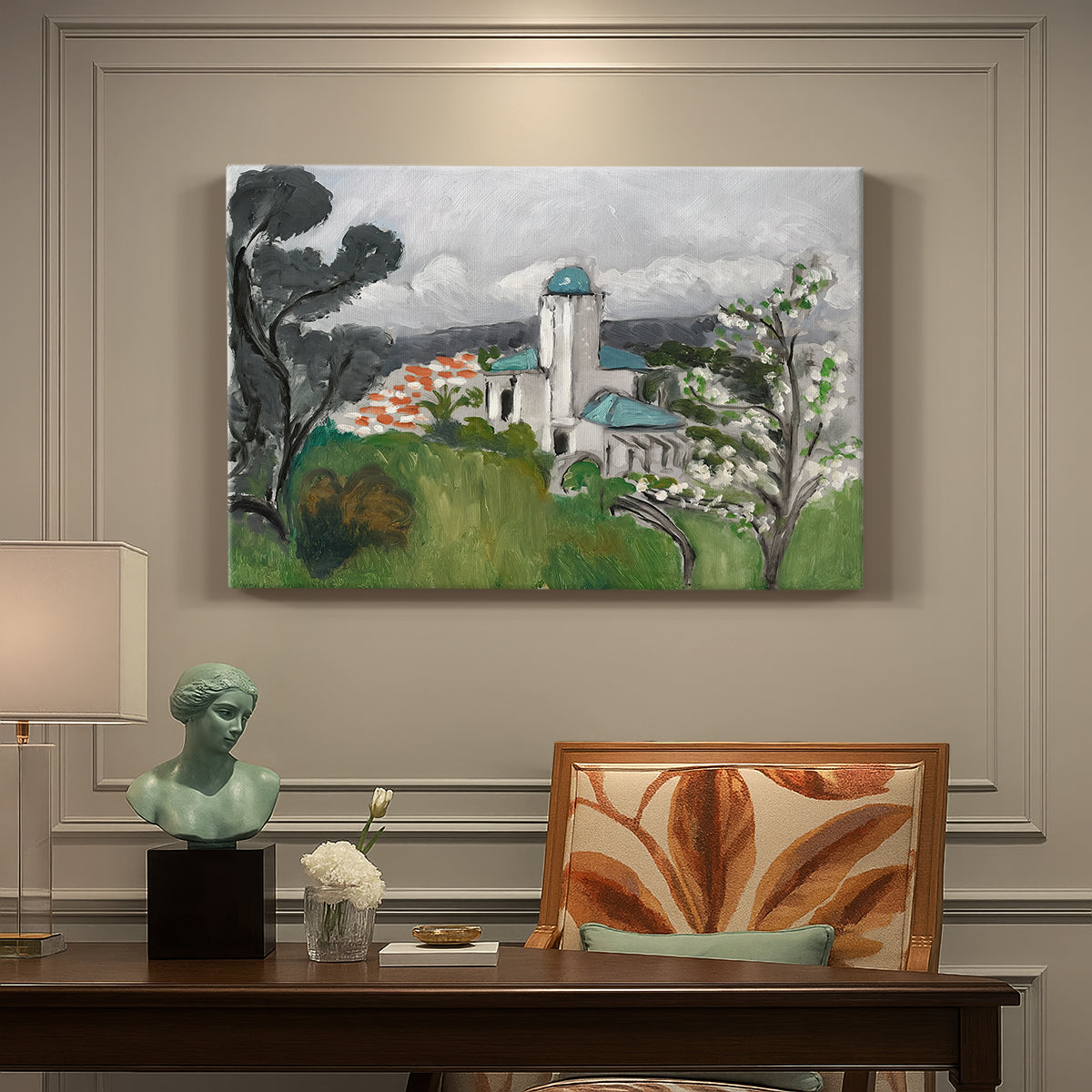 Canvas art print featuring a blue villa surrounded by trees and greenery in a bright landscape, presented within a refined interior setting