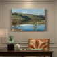 Canvas art print featuring a dramatic landscape with dark thunderclouds forming over distant water and hills, presented within a refined interior setting