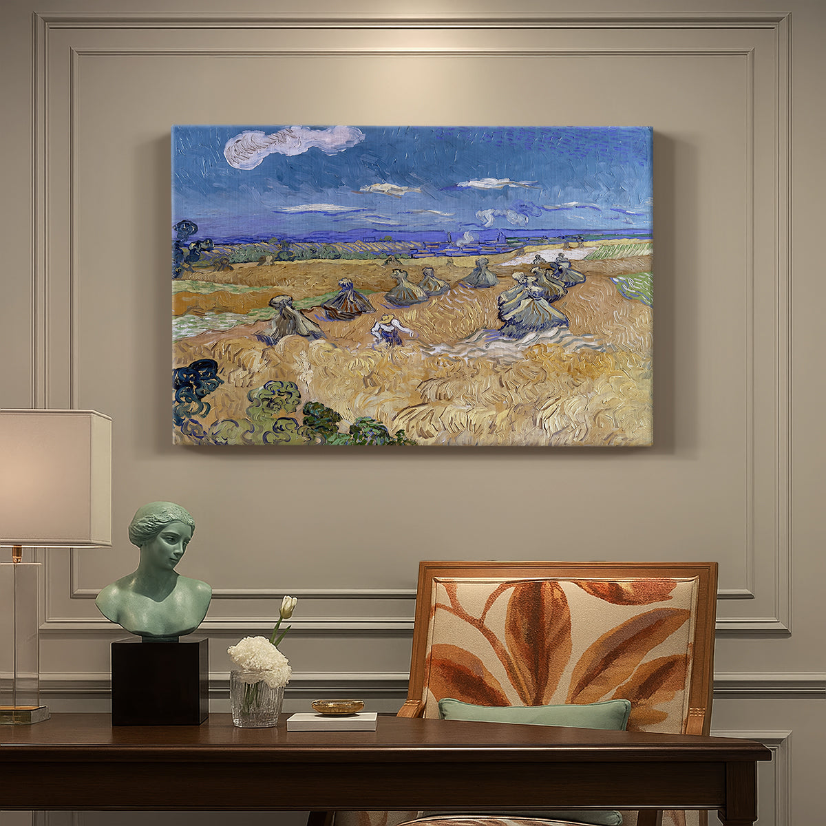 Canvas art print featuring a figure harvesting wheat in expansive field under bright sky, presented within a refined interior setting