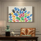 Canvas art print featuring an abstract arrangement of colorful leaf-like cut-outs, presented within a refined interior setting