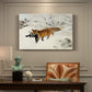 Canvas art print featuring a fox running across snowy landscape with sparse vegetation, presented within a refined interior setting