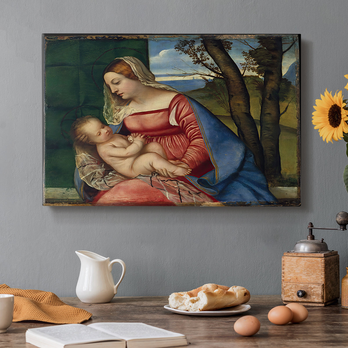 Canvas art print featuring a Madonna cradling child in close devotional scene with rich blue and red garments, set in a cozy kitchen setting