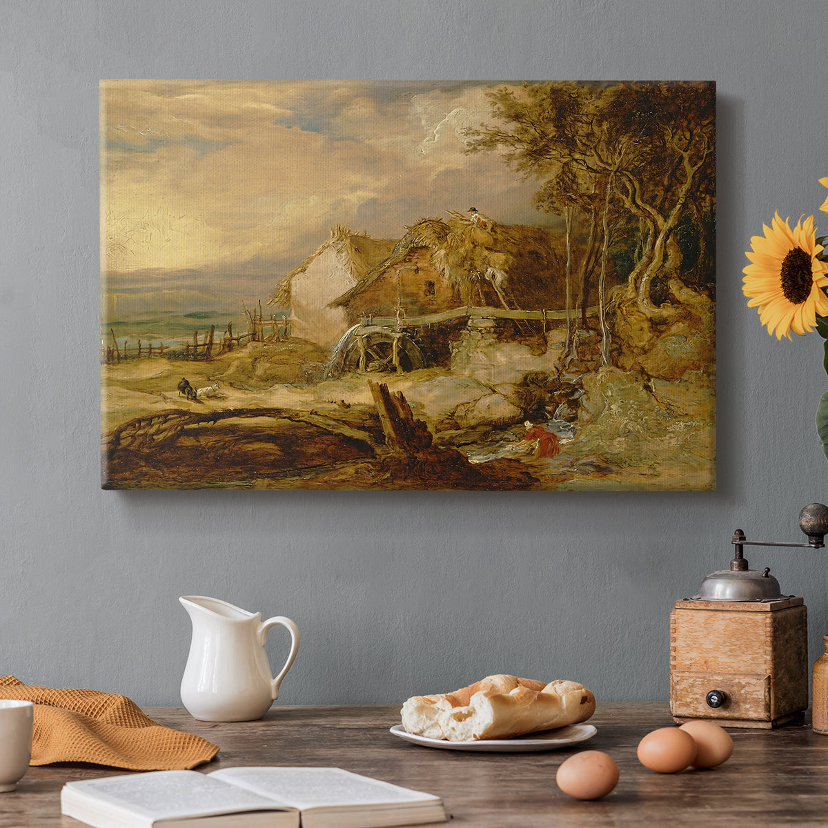 Canvas art print featuring a watermill structure beside flowing stream in rural landscape, set in a cozy kitchen setting