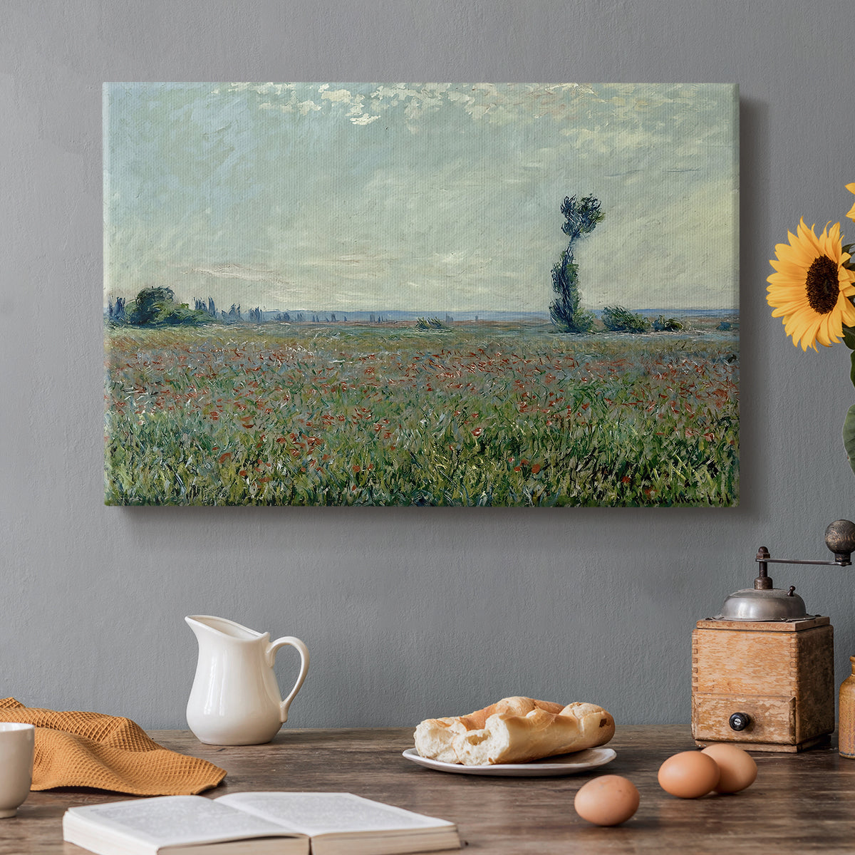 Canvas art print featuring a wide field of red poppies stretching across countryside under open sky, set in a cozy kitchen setting