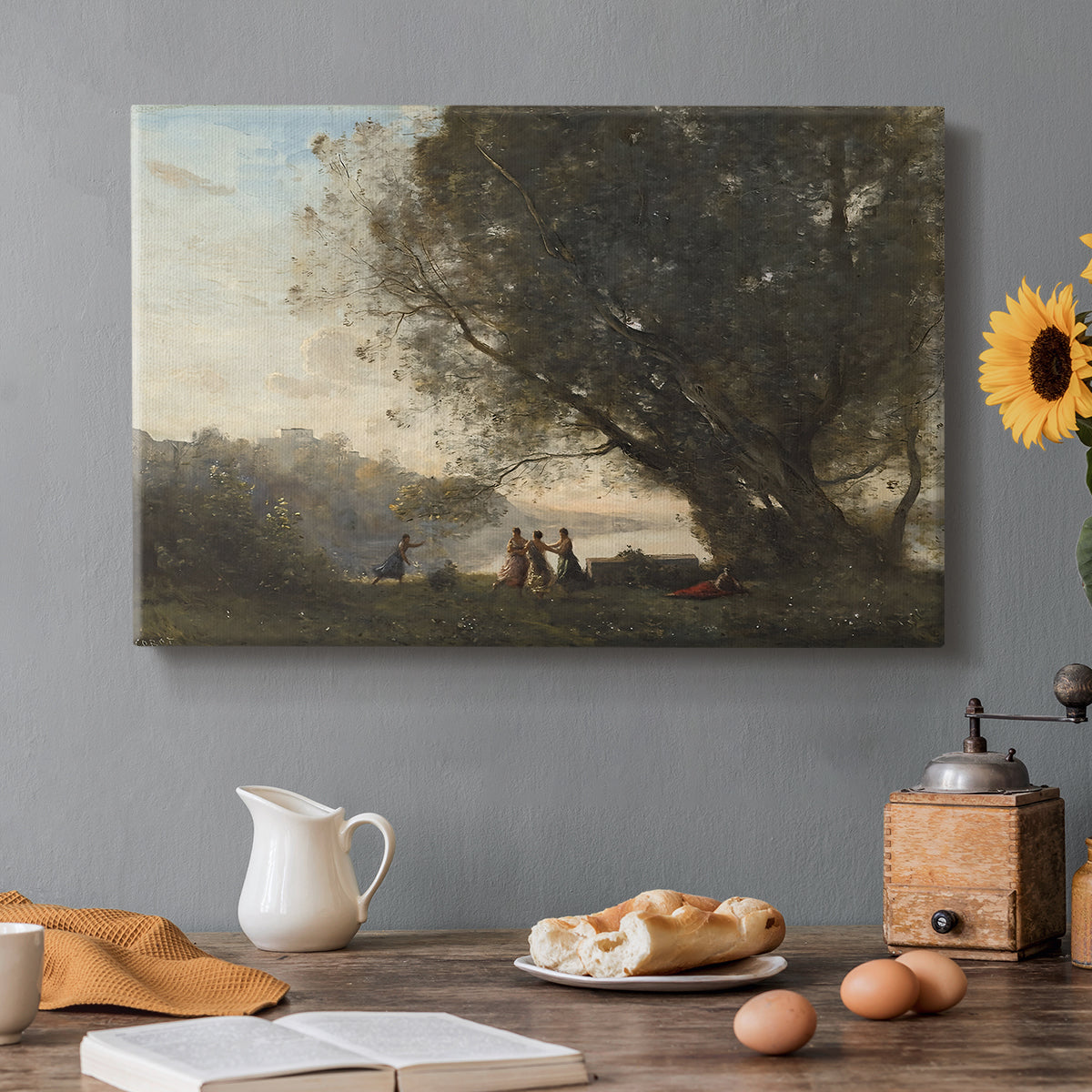 Canvas art print featuring figures dancing beneath trees beside calm lakeside setting, set in a cozy kitchen setting