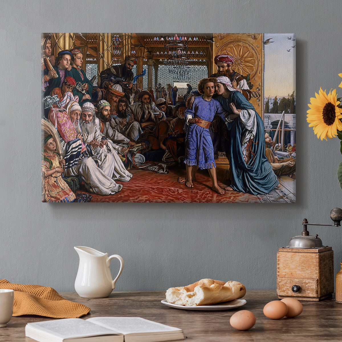 Canvas art print featuring a large group gathered in temple interior around central young figure, set in a cozy kitchen setting