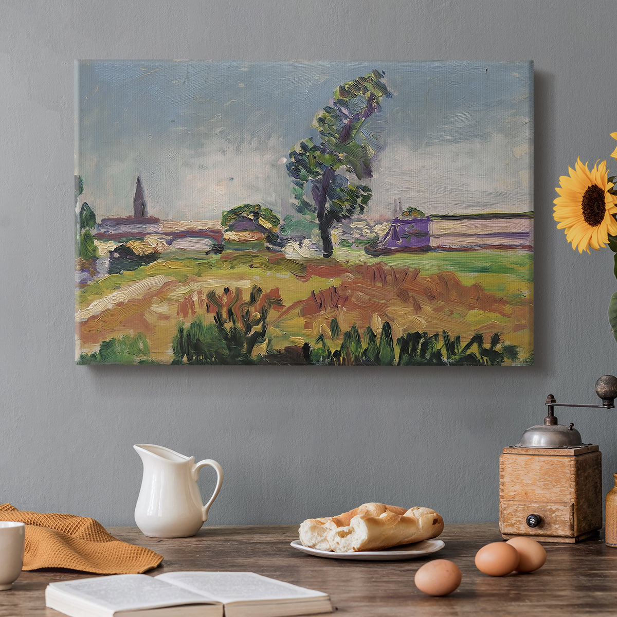 Canvas art print featuring a bridge spanning a river in a quiet landscape with trees and open sky, set in a cozy kitchen setting