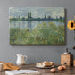Canvas art print featuring a riverbank landscape with water, trees, and distant village buildings, set in a cozy kitchen setting