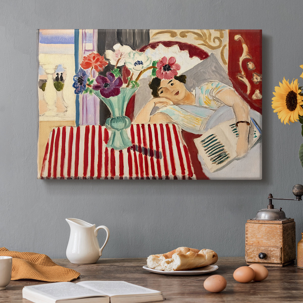 Canvas art print featuring a seated woman beside vase of anemones in richly patterned interior, set in a cozy kitchen setting