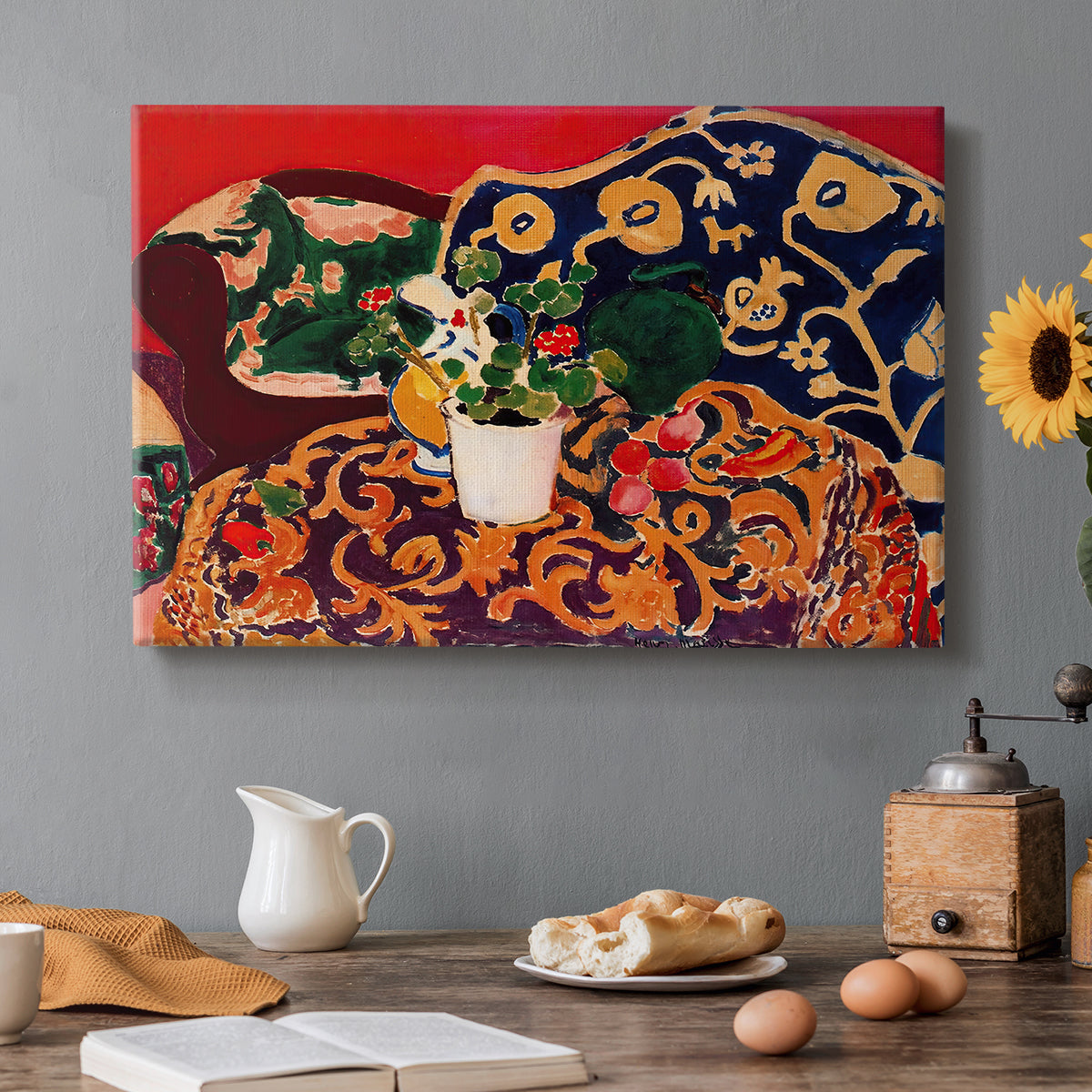 Canvas art print featuring a vibrant still life with fruit, vessels, and patterned objects on a table, set in a cozy kitchen setting