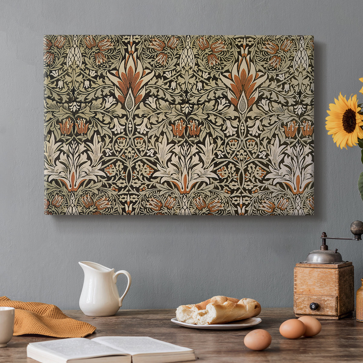 Canvas art print featuring a repeating floral pattern with dark background and warm-toned plant forms, set in a cozy kitchen setting