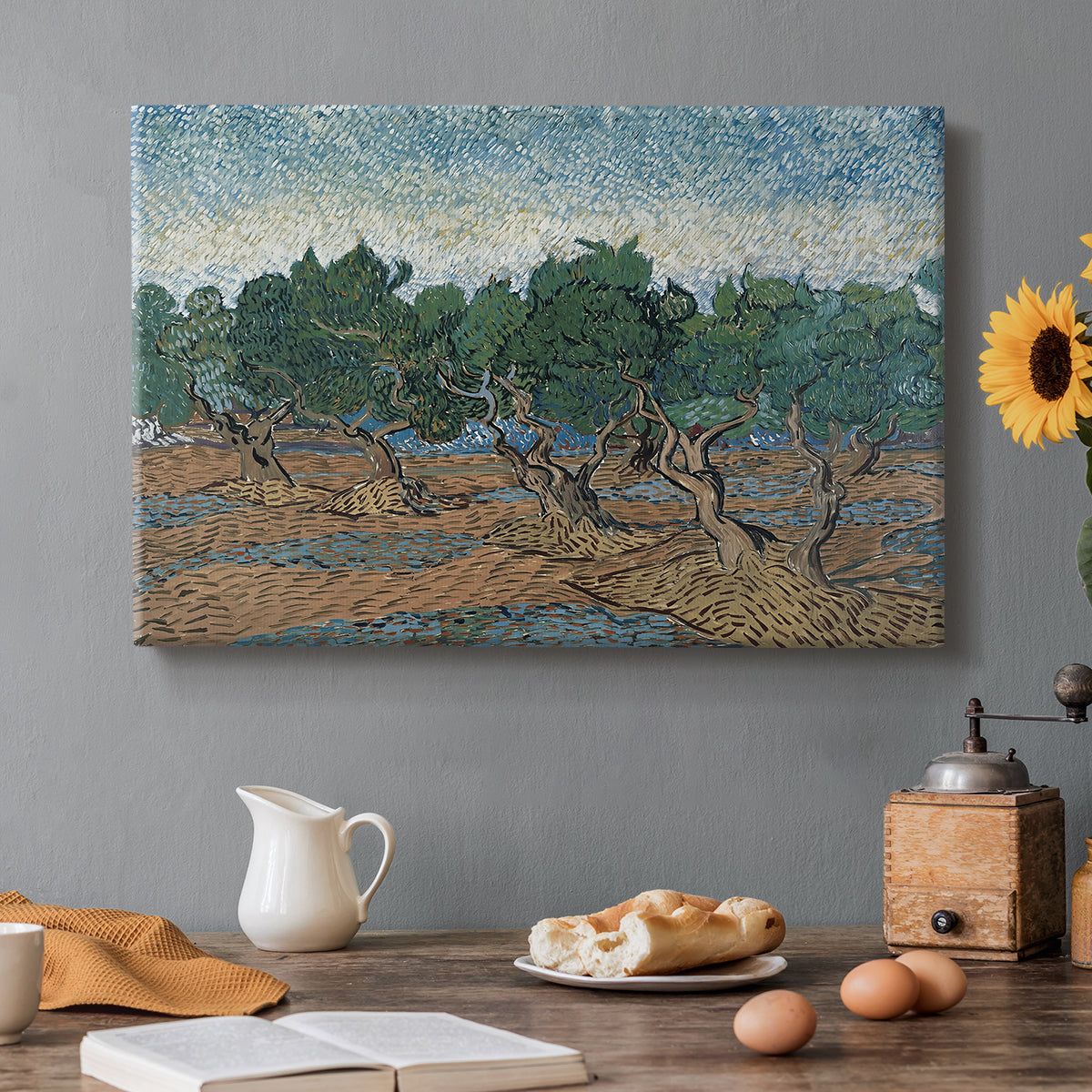 Canvas art print featuring twisting olive trees set within rolling landscape under vibrant sky, set in a cozy kitchen setting