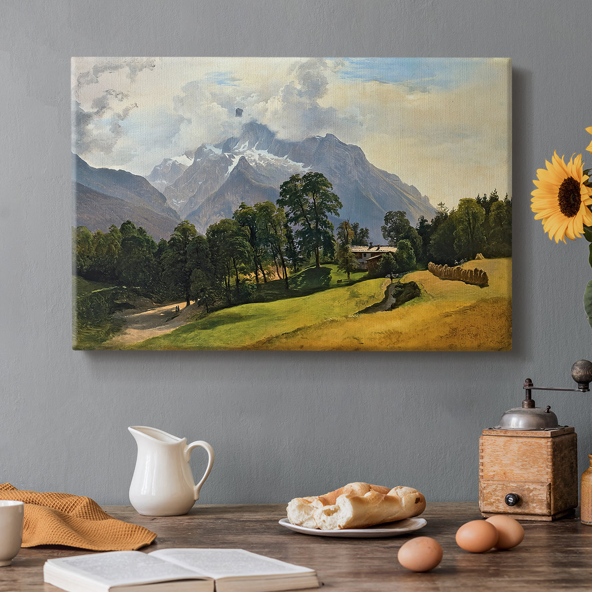 Canvas art print featuring an alpine mountain landscape with towering peaks and valley below, set in a cozy kitchen setting