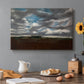Canvas art print featuring a wide landscape beneath heavy grey clouds, set in a cozy kitchen setting