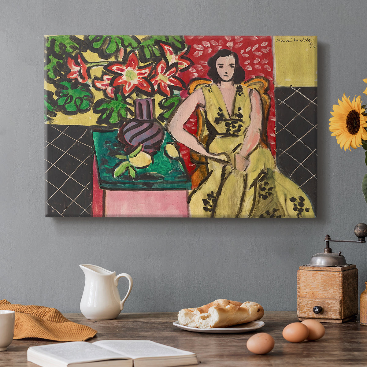Canvas art print featuring a seated woman beside a vase of amaryllis in a richly patterned interior, set in a cozy kitchen setting