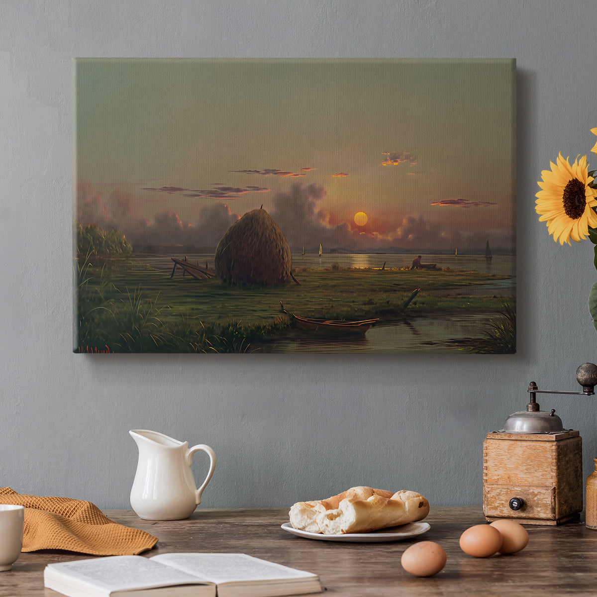 Canvas art print featuring a haystack in field under warm sunset sky, set in a cozy kitchen setting