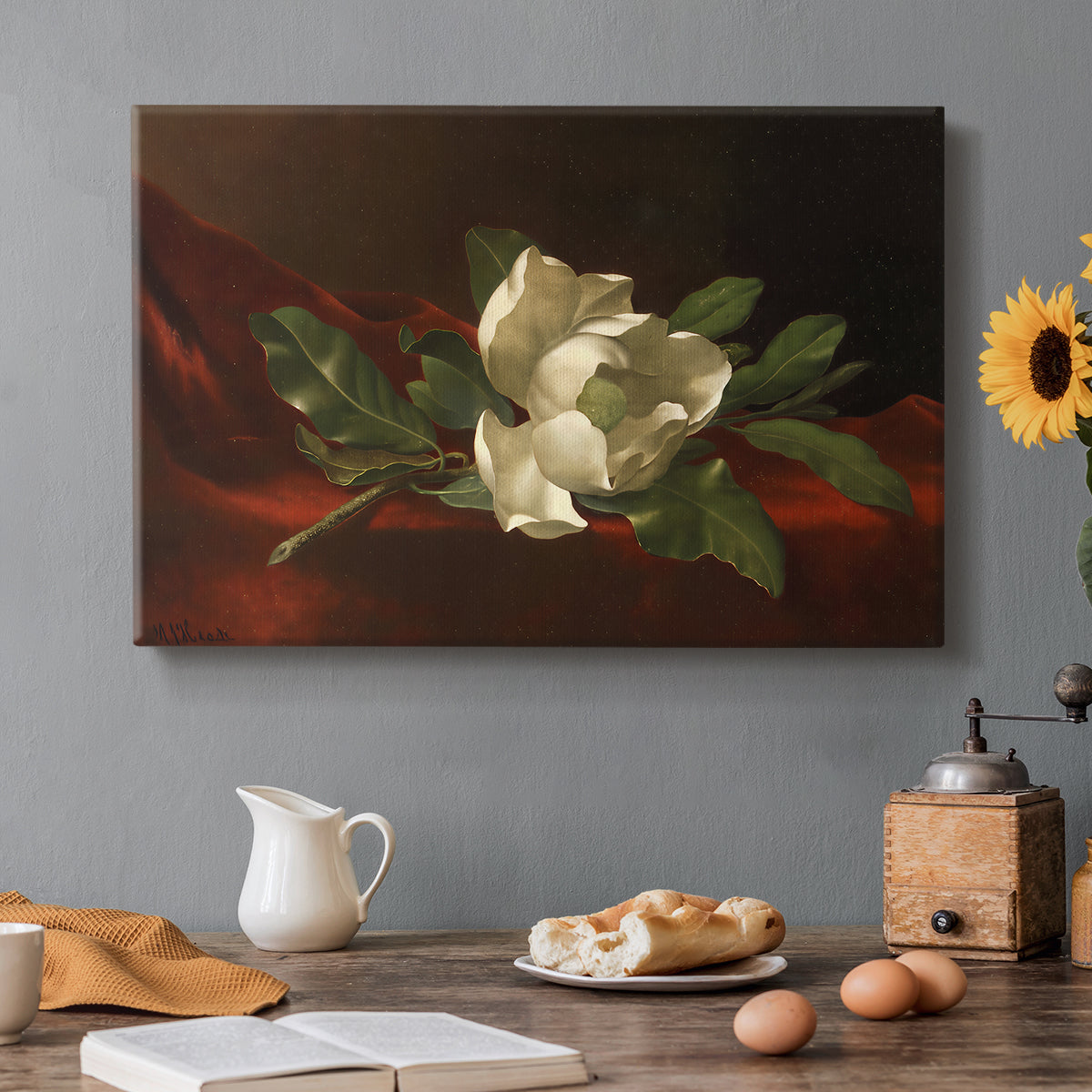 Canvas art print featuring a white magnolia bloom resting on red velvet surface, set in a cozy kitchen setting