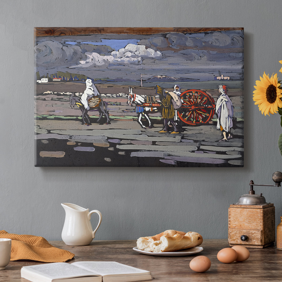 Canvas art print featuring a rural road scene with figures and landscape rendered in bold color and simplified forms, set in a cozy kitchen setting