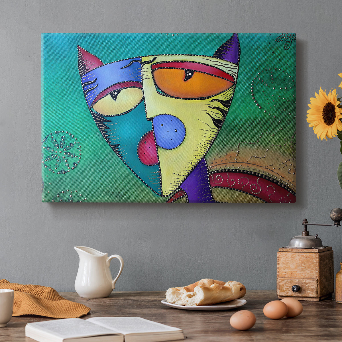 Canvas art print featuring a colorful geometric cat face with angular shapes, set in a cozy kitchen setting