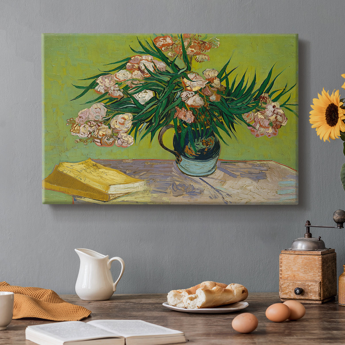 Canvas art print featuring a still life with vase of oleanders placed beside stacked books, set in a cozy kitchen setting