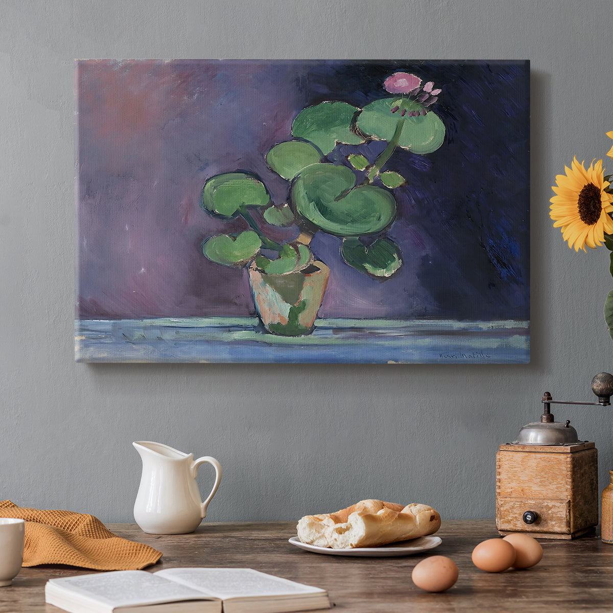 Canvas art print featuring a potted geranium with green leaves and blossoms against a dark background, set in a cozy kitchen setting