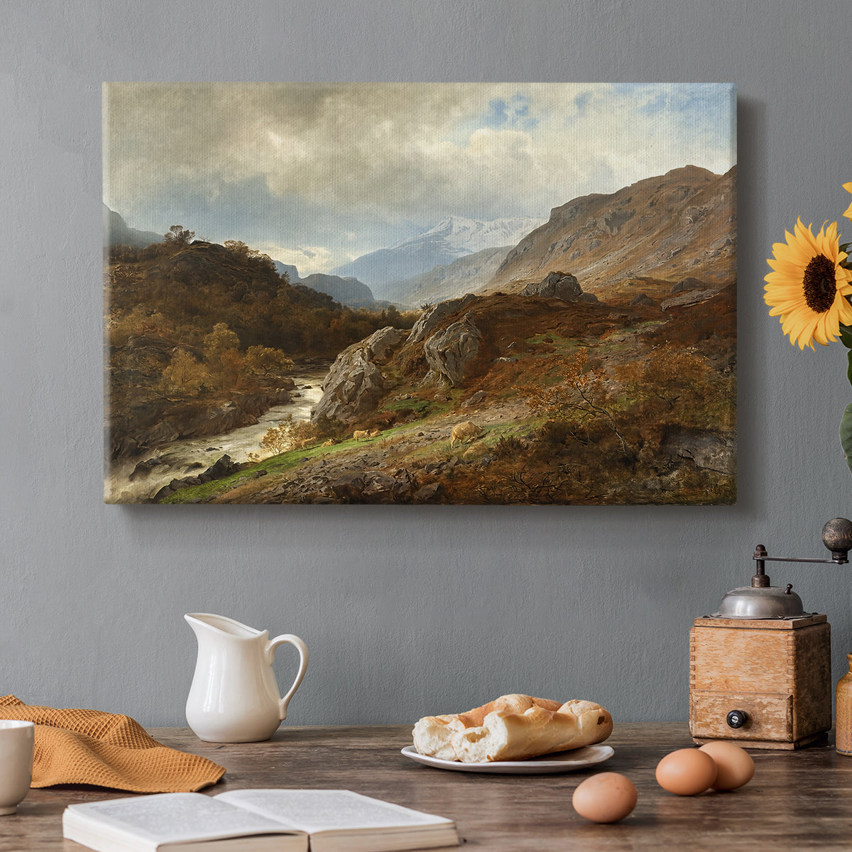 Canvas art print featuring a rugged mountain terrain with valley and distant peaks under open sky, set in a cozy kitchen setting
