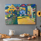 Canvas art print featuring a village street with colorful houses and trees lining a narrow road, set in a cozy kitchen setting