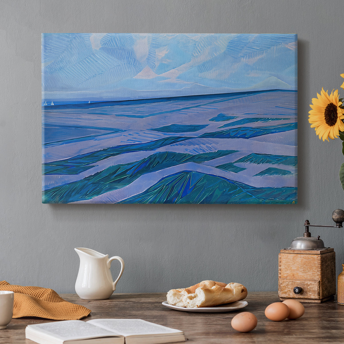 Canvas art print featuring coastal dunes and water in horizontal color bands, set in a cozy kitchen setting