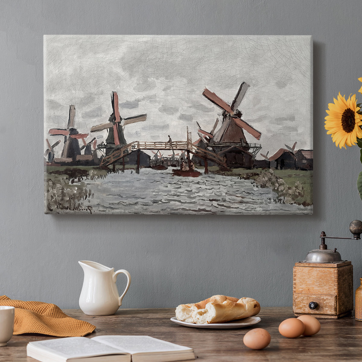 Canvas art print featuring windmills standing beside water under open sky in rural landscape, set in a cozy kitchen setting