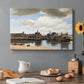 Canvas art print featuring a cityscape of Delft with buildings reflected in calm water, set in a cozy kitchen setting