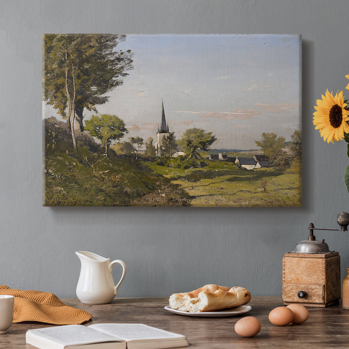 Canvas art print featuring a rural village with church surrounded by trees and open land, set in a cozy kitchen setting