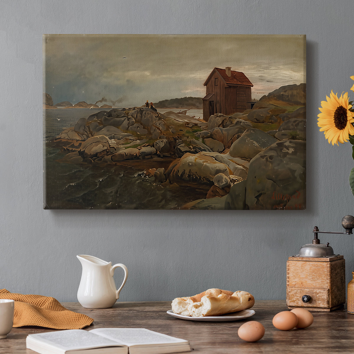 Canvas art print featuring a coastal home near shoreline with boats and surrounding landscape, set in a cozy kitchen setting