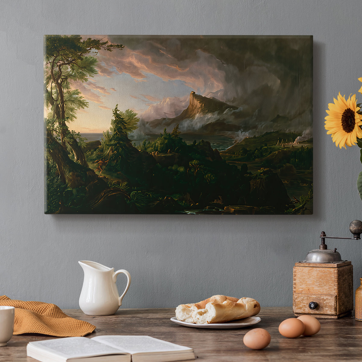 Canvas art print featuring an untamed wilderness landscape with scattered figures and primitive activity, set in a cozy kitchen setting