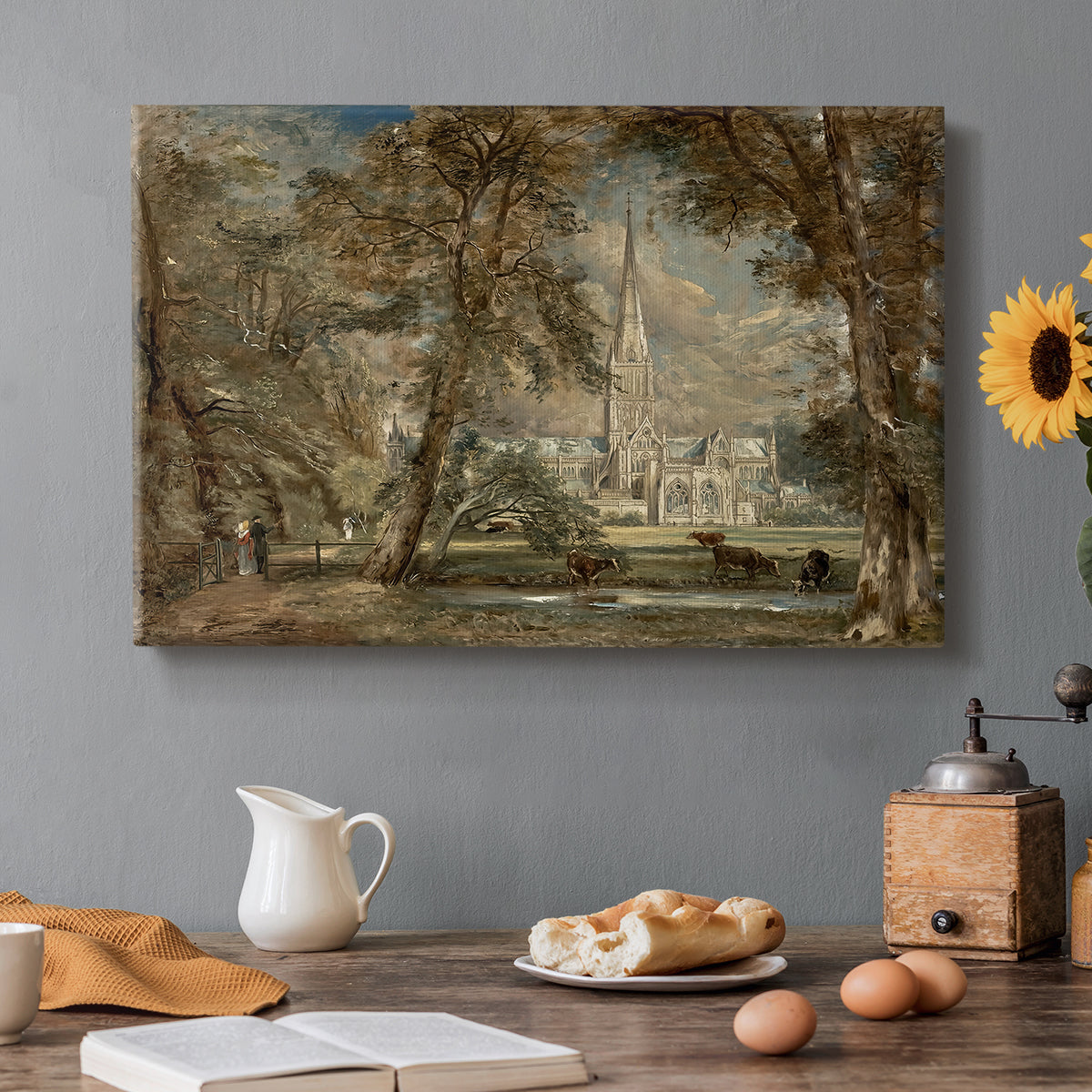 Canvas art print featuring a cathedral rising above landscape with trees and field, set in a cozy kitchen setting