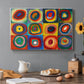 Canvas art print featuring a grid of squares each containing concentric circular color patterns, set in a cozy kitchen setting