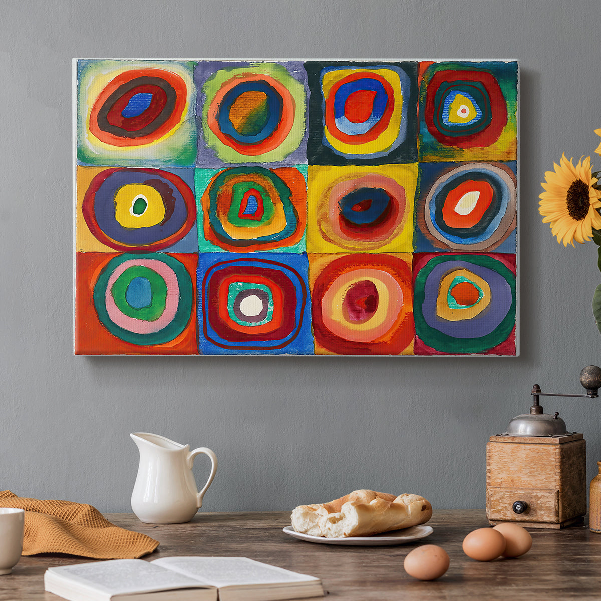 Canvas art print featuring a grid of squares each containing concentric circular color patterns, set in a cozy kitchen setting