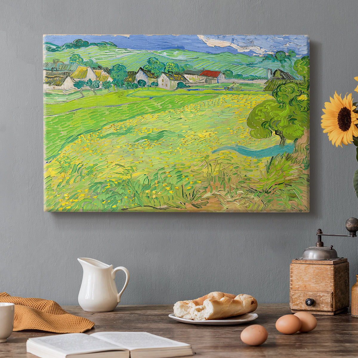 Canvas art print featuring a rolling hillside landscape with houses and fields under wide sky, set in a cozy kitchen setting
