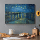 Canvas art print featuring a night scene with glowing stars reflected in river beside illuminated town, set in a cozy kitchen setting