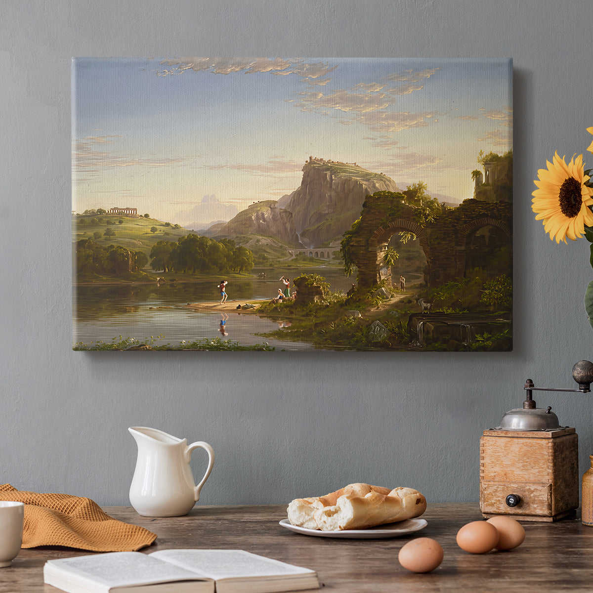 Canvas art print featuring a sunlit pastoral landscape with figures and classical architecture in open countryside, set in a cozy kitchen setting