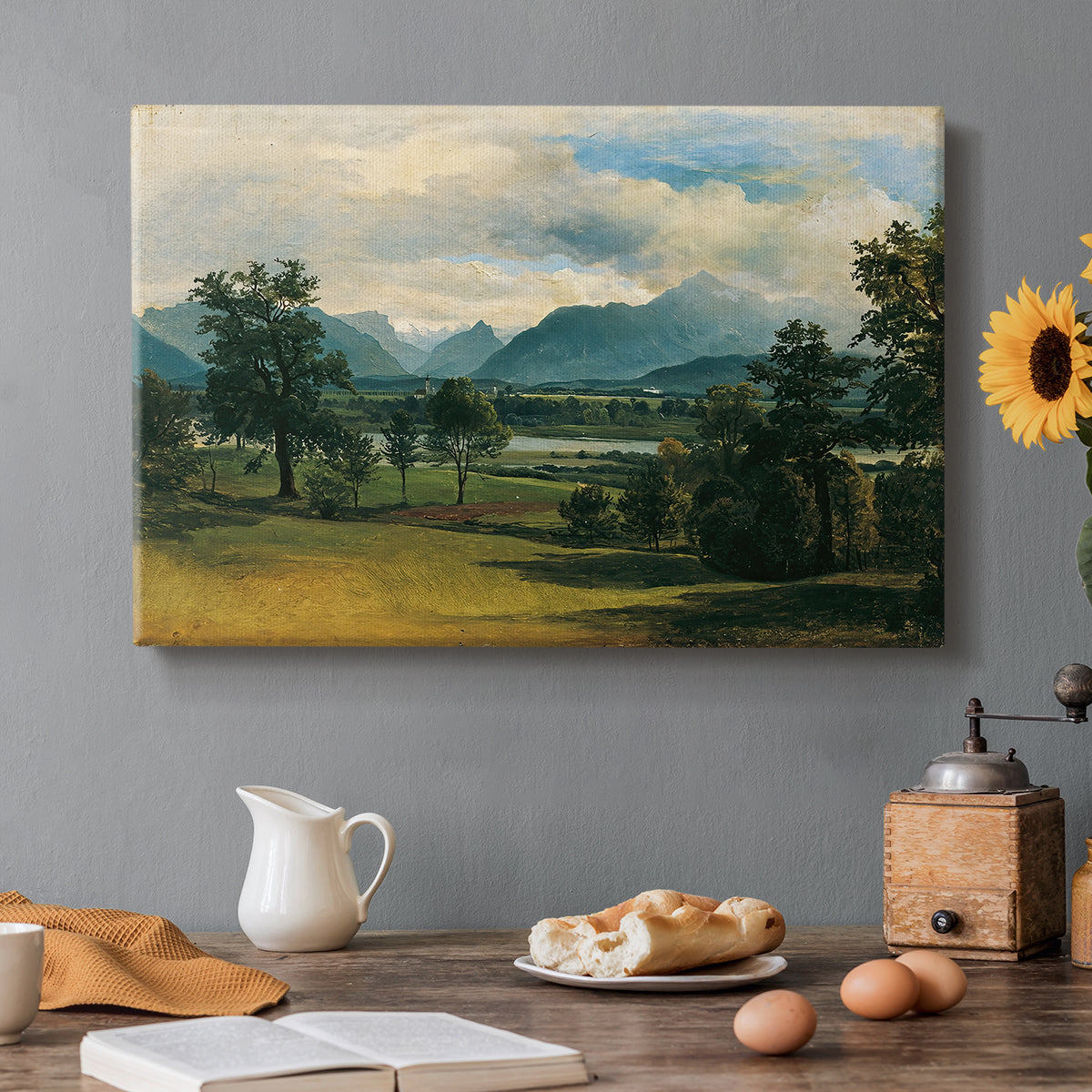 Canvas art print featuring a village landscape and countryside under wide sky, set in a cozy kitchen setting