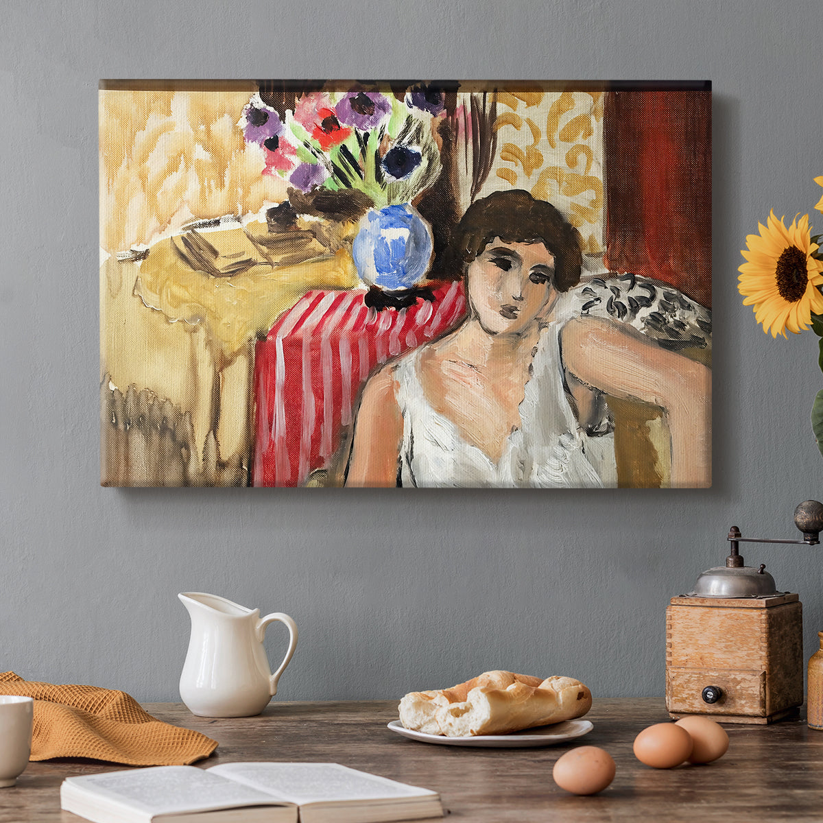Canvas art print featuring a seated woman in an armchair in a colorful interior, set in a cozy kitchen setting