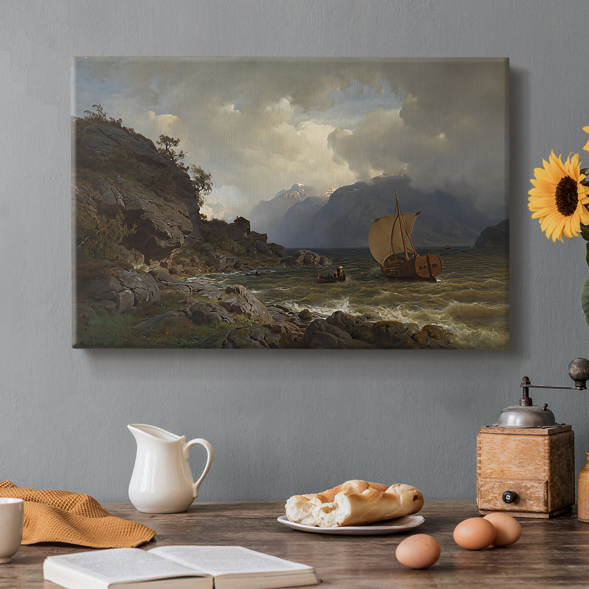 Canvas art print featuring a rugged Norwegian coastline with cliffs, water, and distant boats, set in a cozy kitchen setting