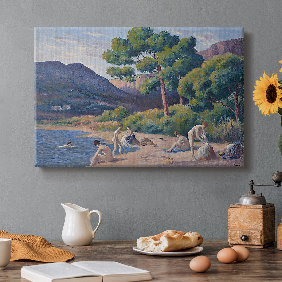 Canvas art print featuring figures bathing along shoreline in bright coastal landscape, set in a cozy kitchen setting